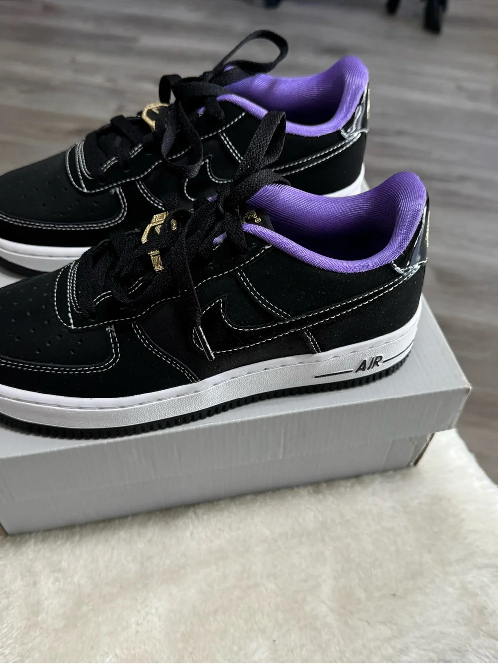 Nike Kids Black Sneakers with Purple Lining and Gold Lace Accent